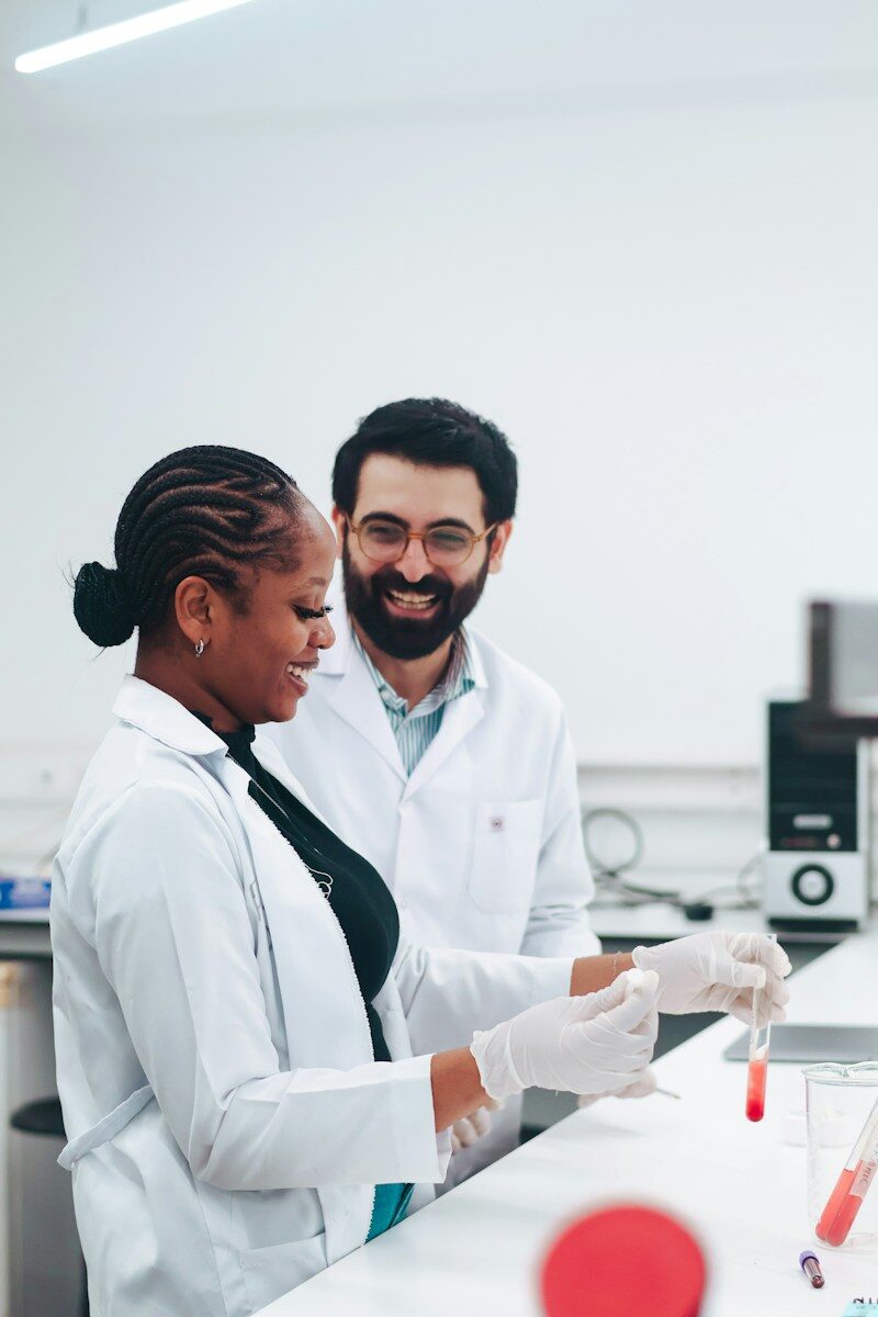 Two scientists working with test tubes in a lab